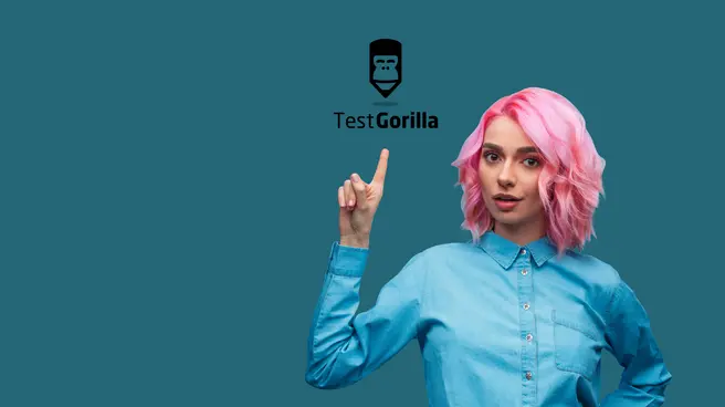 A woman pointing at the TestGorilla logo.
